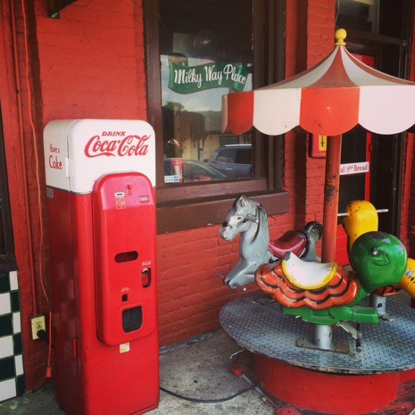 vintage carousel and coke machine