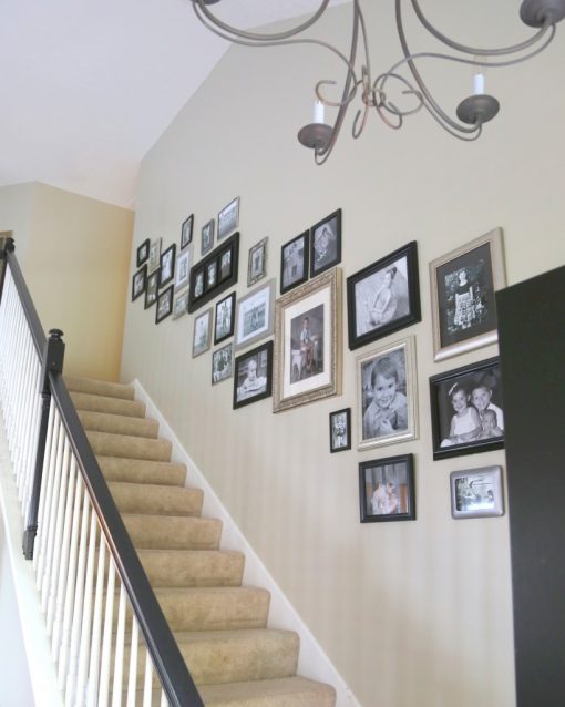 Hanging Family Photos in an Open Stairwell - The Decorologist