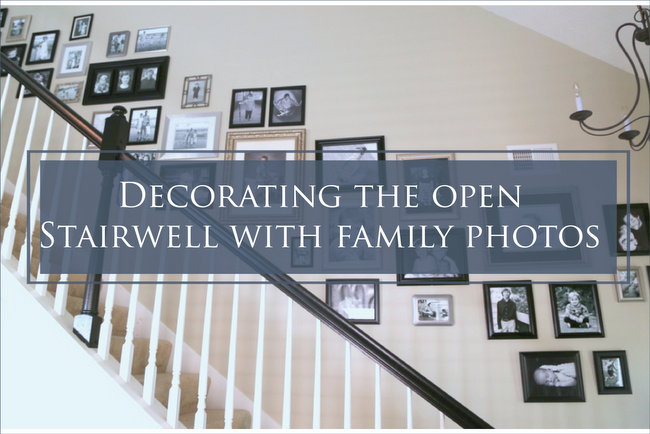 hanging family photos in stairwell