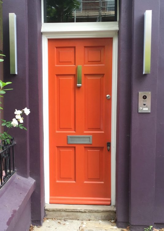 bright orange front door paint color that looks like Sherwin-Williams Obstinate Orange SW 6884