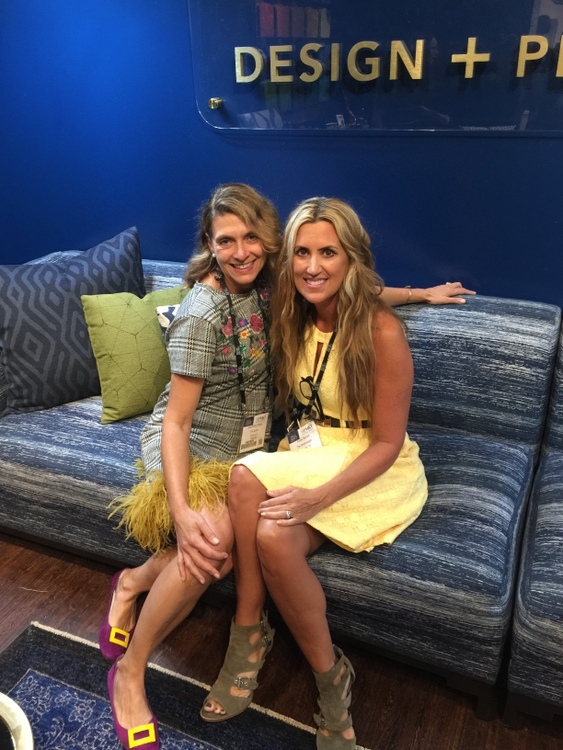 Sunbrella fabric showroom with royal blue walls and blue patterned sofa with Trim Queen Jana Phipps and The Decorologist Kristie Barnett