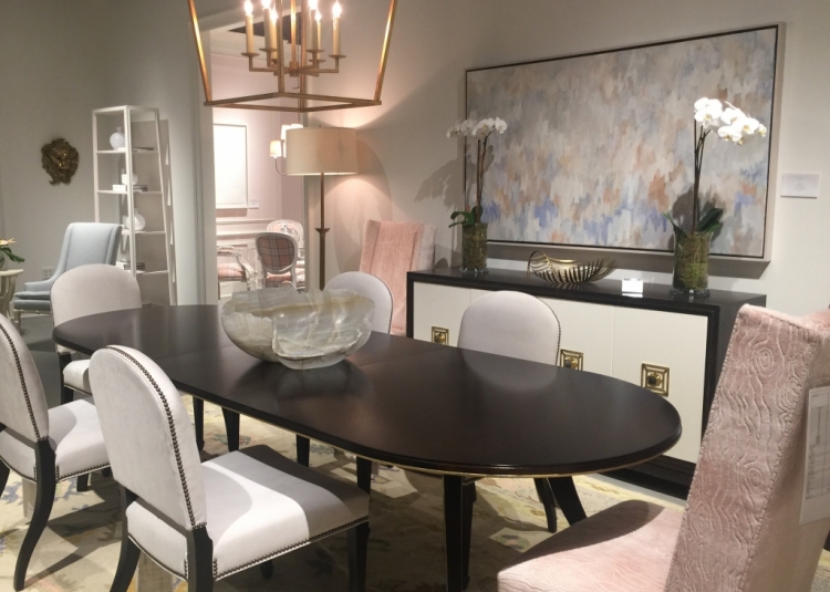 Highland House dining room in High Point Furniture Market showroom with pink upholstered chairs and white chairs