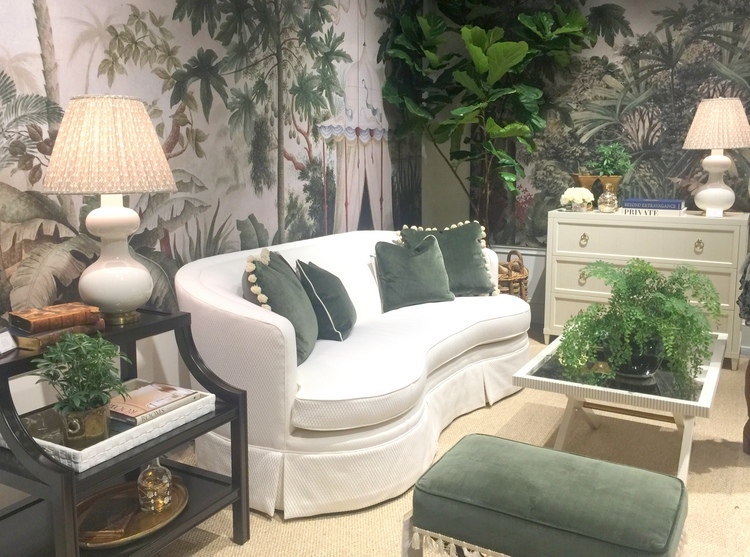 white sofa, green leaf wallpaper, forest green pillows and upholstery at Highland House furniture showroom