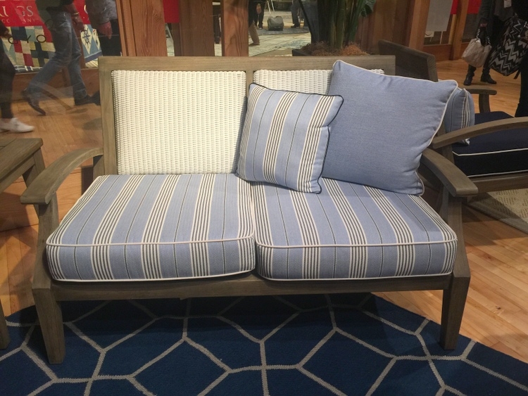 lloyd flanders outdoor furniture showroom with blue and white upholstered bench