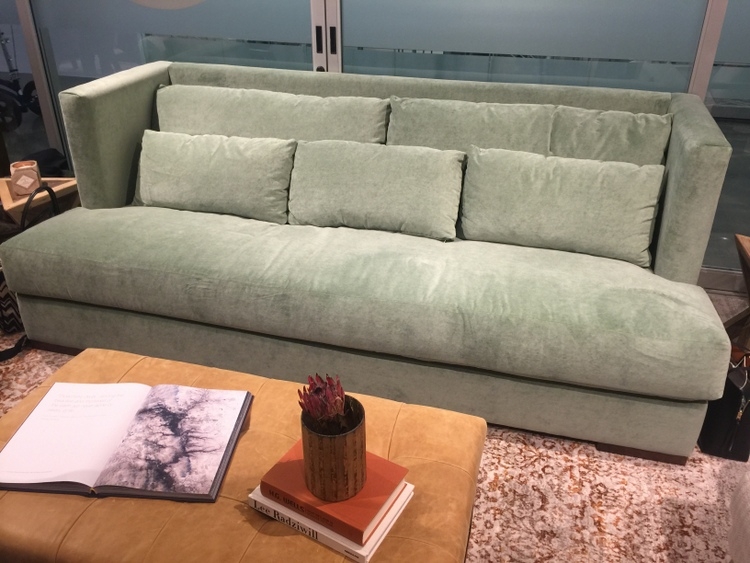 mint green sofa in Younger Furniture showroom at High Point Furniture Market