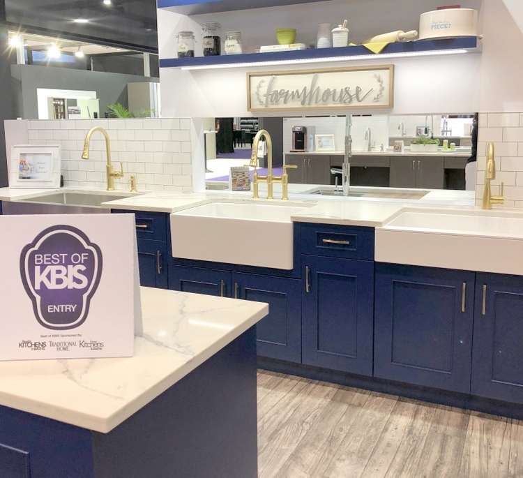 farmhouse style kitchen at 2018 KBIS with navy blue kitchen cabinets and gold faucets