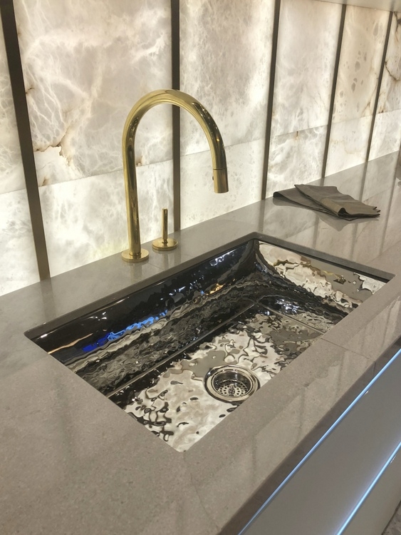 gold faucet with hammered silver farmhouse sink at 2018 KBIS