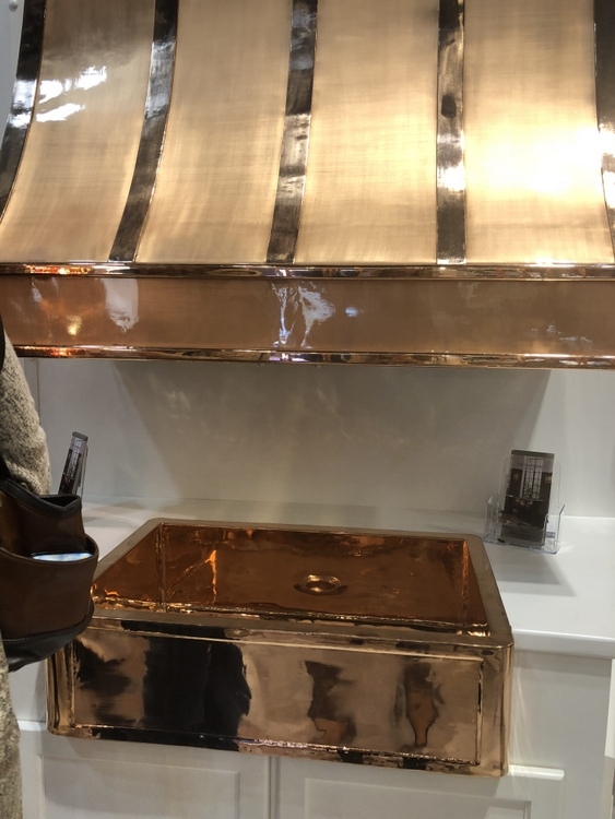 statement range hood and farmhouse sink in gold and copper at 2018 KBIS