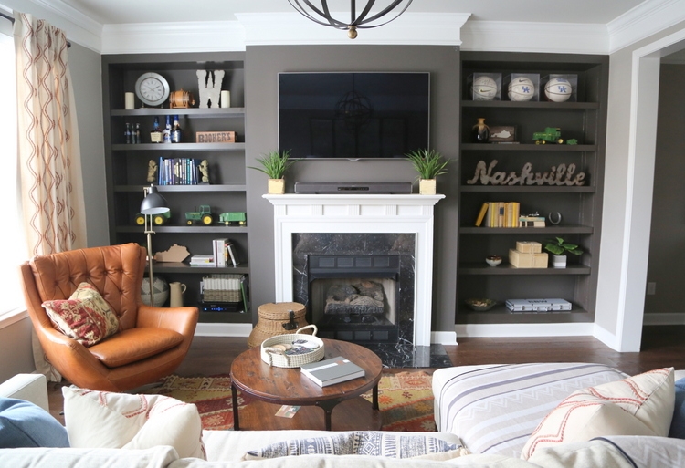 dark gray bookcases with midcentury leather swivel chair Nashville design by The Decorologist