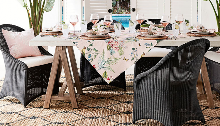 pink floral tablecloth and charcoal wicker chairs