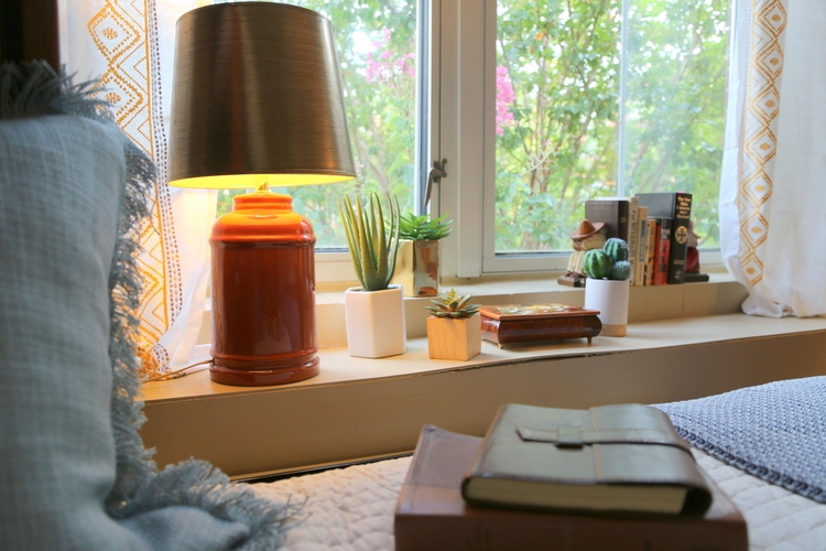 window ledge in dorm room with vintage orange lamp and succulents