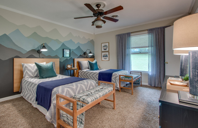 outdoor lodge themed boys guest bedroom with mountain range mural by the decorologist