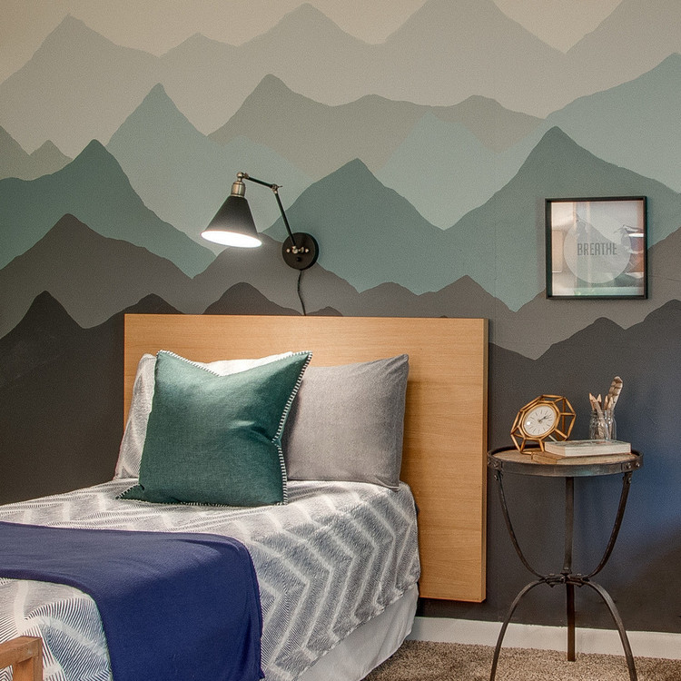 mountain mural in woodsy room with plug in reading lamps