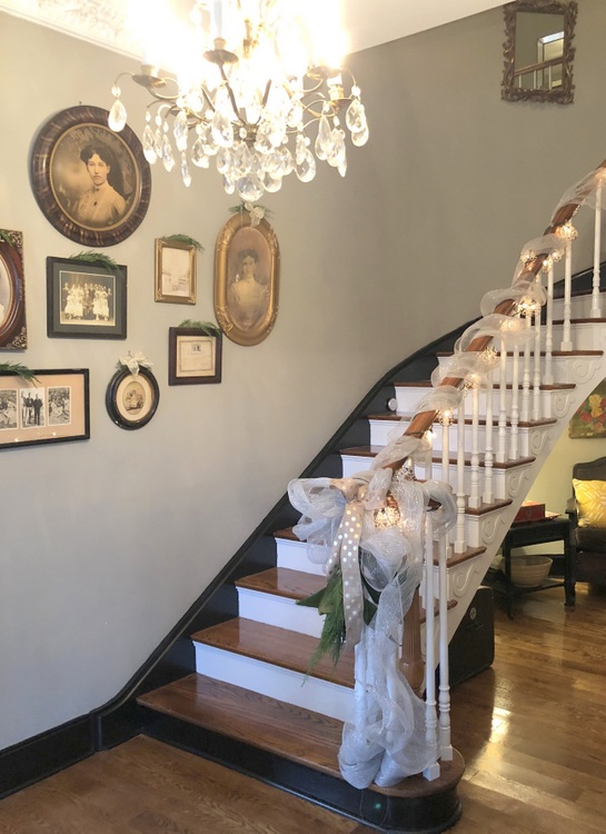 curved staircase in historic home with black base molding