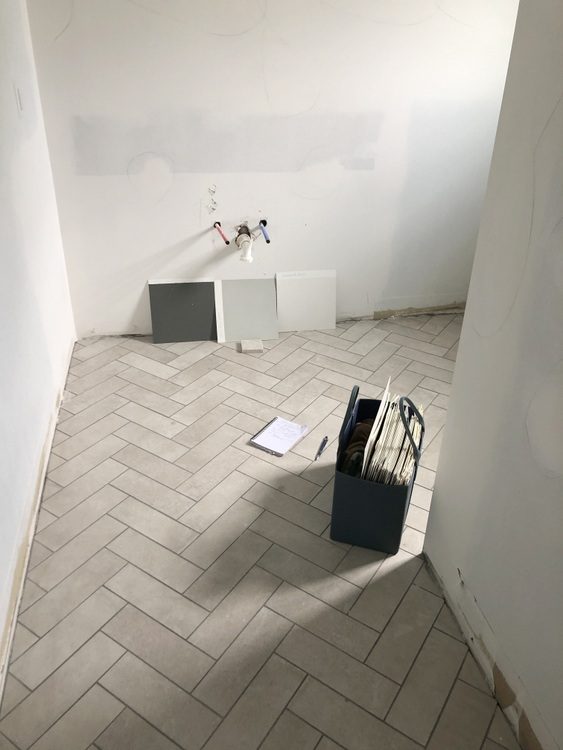 herringbone tile pattern on bathroom floor