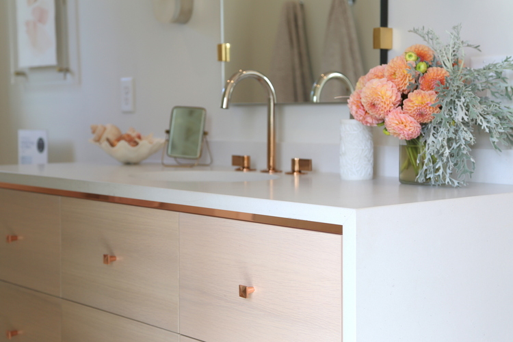 blush bathroom cabinet and rose gold fixtures