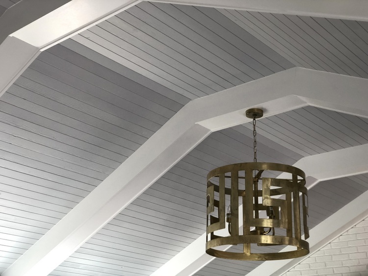 white beam vaulted ceiling with gold light fixture