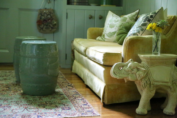 vintage revival rug with yellow sofa green garden stools salisbury green walls