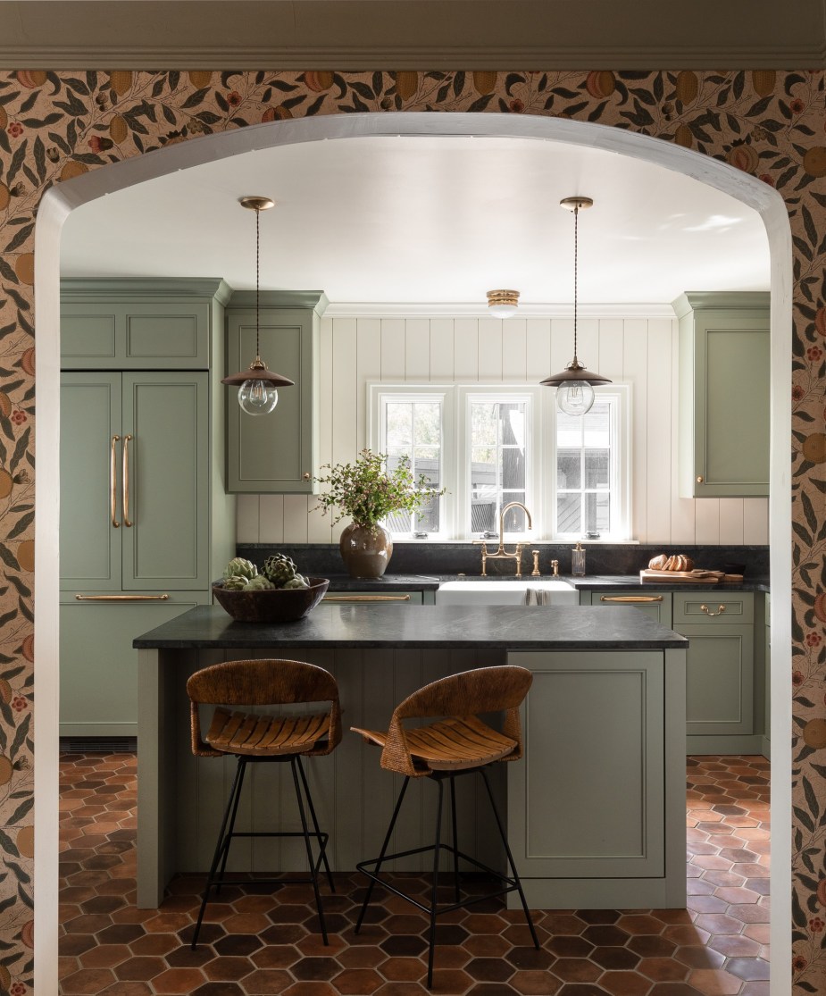 Sage green kitchen with shaker cabinets in a renovated 1880s house