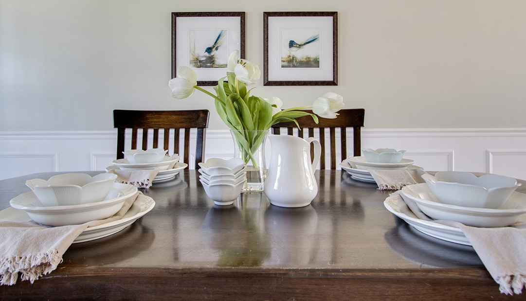 home staged dining room table with artwork