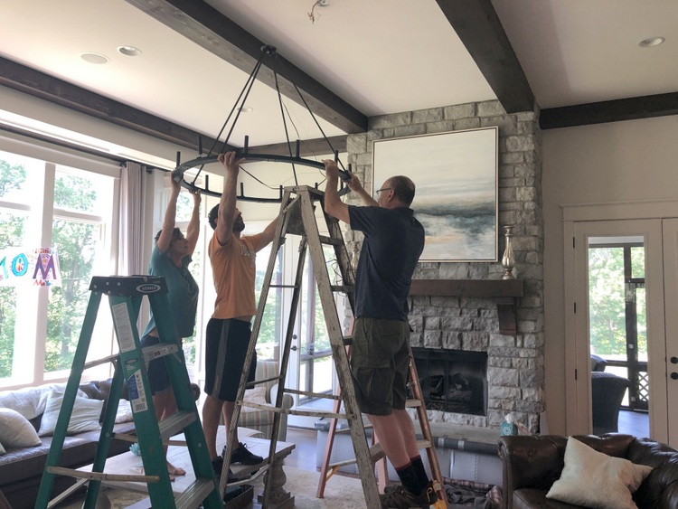 large light fixture hanging from wood beams