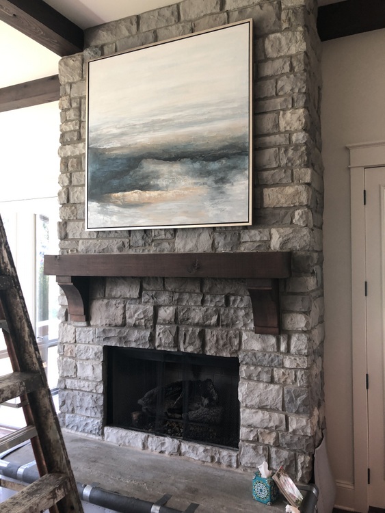 blue abstract art on stone fireplace