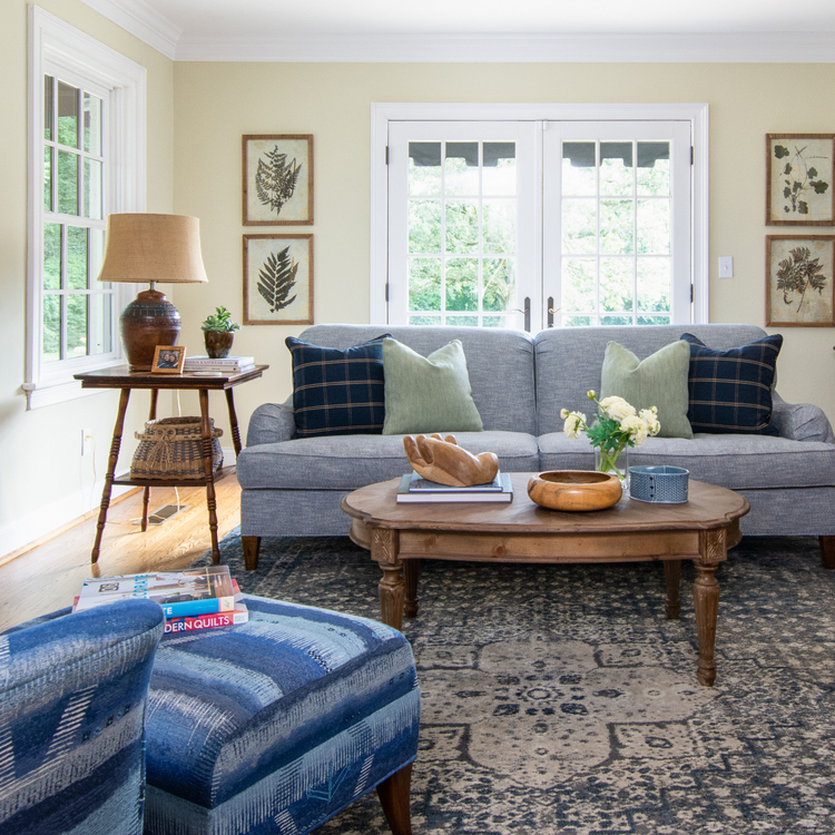 blue sofa with botanical art and mixed wood tones