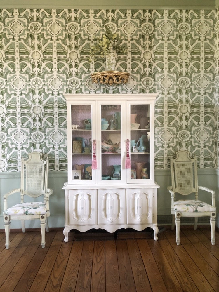 white painted china hutch with green geometric cole & son wallpaper