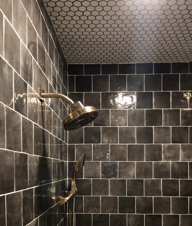 black glazed bathroom shower tile and tiled ceiling