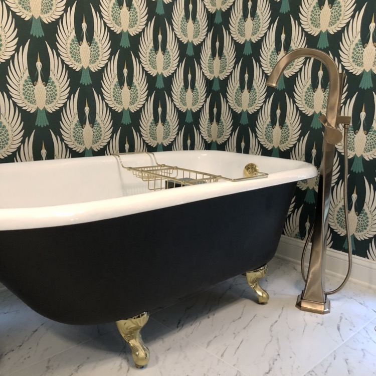 black clawfoot tub in art deco bathroom